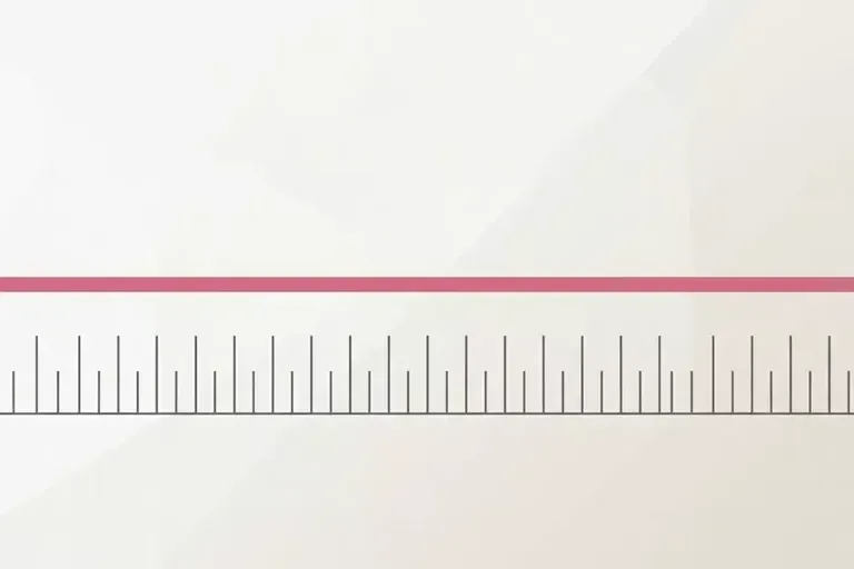 A nearly blank white surface with a pink horizontal bar across it, above a ruler with tick marks.